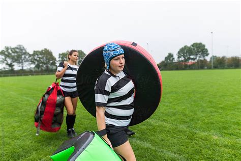 Two Female Rugby Players Walking On The Pitch To Practice By Stocksy