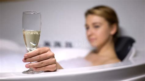 Elegant Lady Holding Champagne Glass In Bath With Foam Bubbles Rest And Relax Stock Image