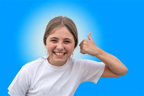 Portrait Of Beautiful Smiling Teenage Girl Giving Thumbs Up Isolated On