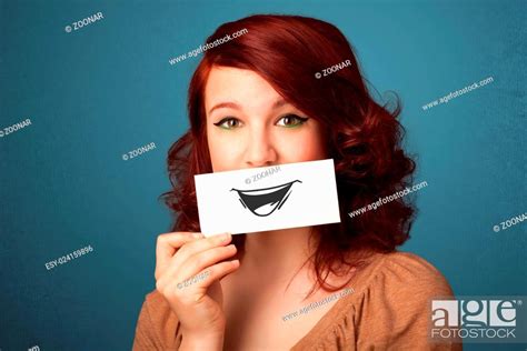 Happy Cute Girl Holding Paper With Funny Smiley Drawing Stock Photo