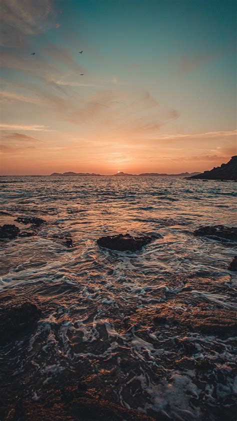 Download Wallpaper 1440x2560 Sunset Sea Water Rocks Nature Qhd