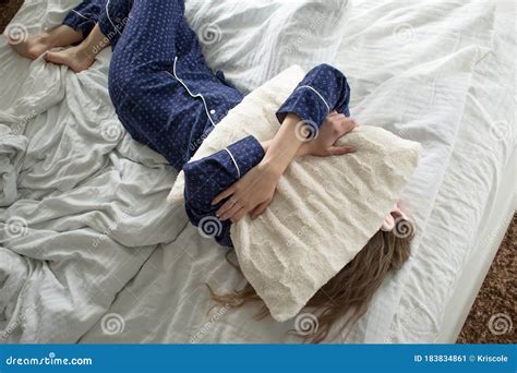 Too Lazy To Get Out Of Bed A Woman Covers Her Face With A Pillow Stock Image Image Of