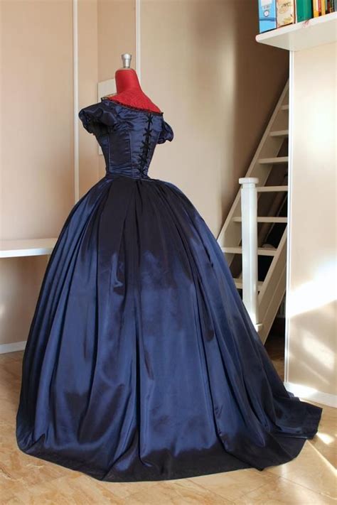 The puff sleeve with bows or the bell sleeve change the bodice. Victorian ball gown in blue taffeta with lace application ...