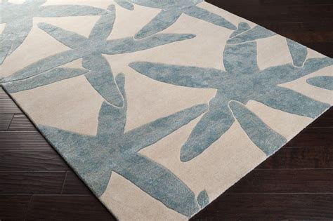 A Blue And White Area Rug With An Abstract Design On The Bottom Along