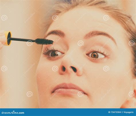 Woman Applying Black Eye Mascara To Her Eyelashes Stock Photo Image