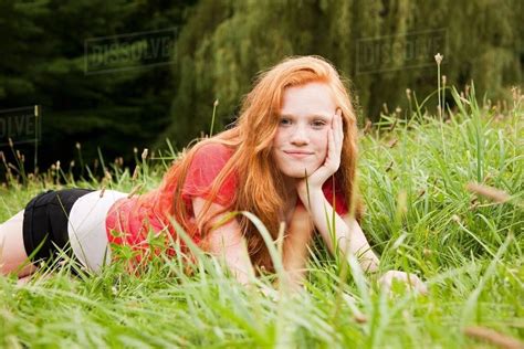 Teenage Girl Lying Down On The Grass Chilling Out Stock Photo Dissolve