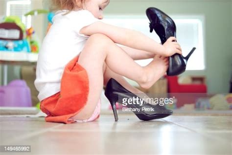 Girl Wearing Her Mommys High Heels Shoes Photo Getty Images