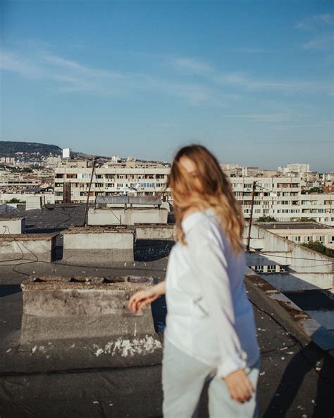 Blurry Portrait Of A Girl Running On A Rooftop Rooftop Photoshoot