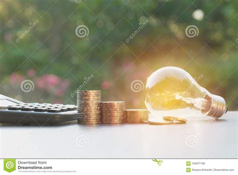 Clock calculator bulb math puzzle. Energy Saving Light Bulb With Stacks Of Coins And ...