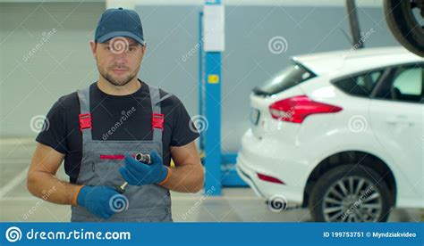 Handsome Professional Car Mechanic Is Working On A Vehicle In A Service