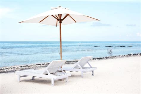 Beach Chairs And Parasol On Exotic Tropical White Sandy Stock Photo