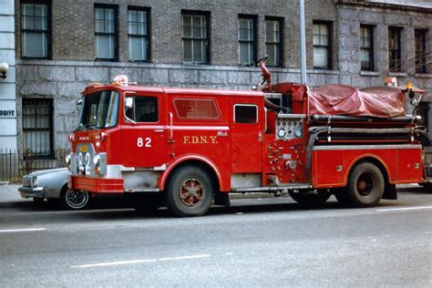 an old fire truck is parked on the street