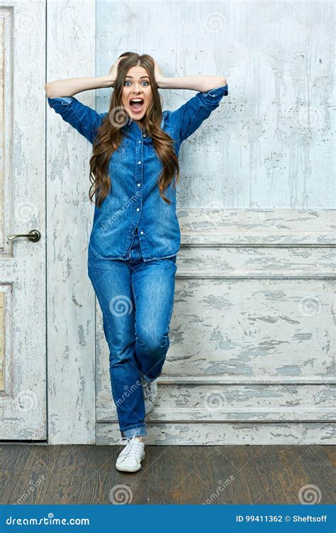 Full Body Portrait Of Young Shocked Woman Standing Against Old Stock