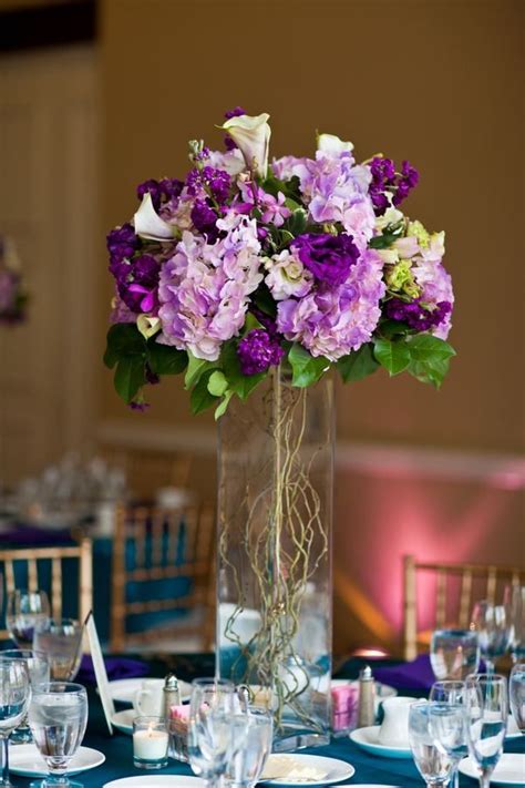 Tall Purplecenterpiece With Willow Branch Inside Cylinder Vase