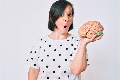 Premium Photo Brunette Woman With Down Syndrome Holding Brain Scared