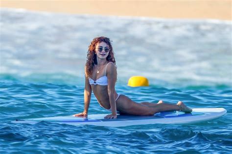 sarah hyland displays her amazing figure in a white bikini as she larks around on a boat in cabo