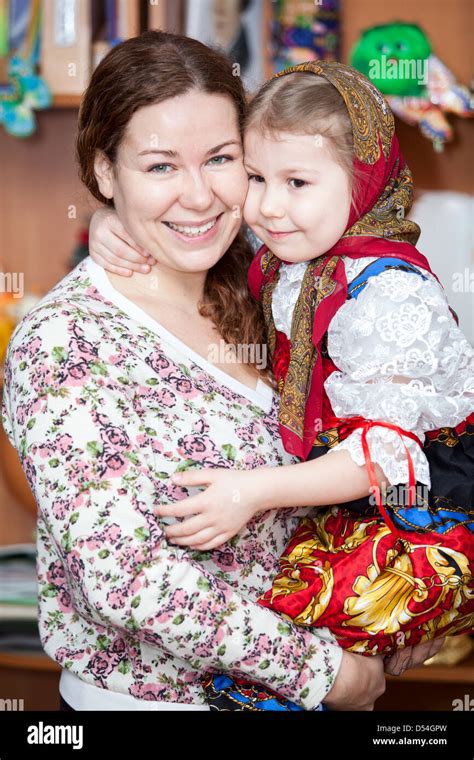 happy mother holding small girl in russian traditional clothes russian people in russia stock