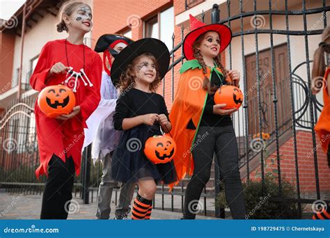 Cute Little Kids Wearing Halloween Costumes Going Trick Or Treating
