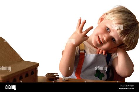 Young Child Photographed On A White Background Holding Up Three Fingers
