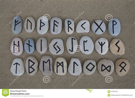 Runic Alphabet On Carved Stones Over The Sand Stock Photo