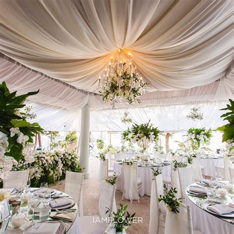 Honeycomb balls look great hanging from a ceiling or a tree, but you can use them pretty. Ceiling draping and chandelier with natural green wedding ...