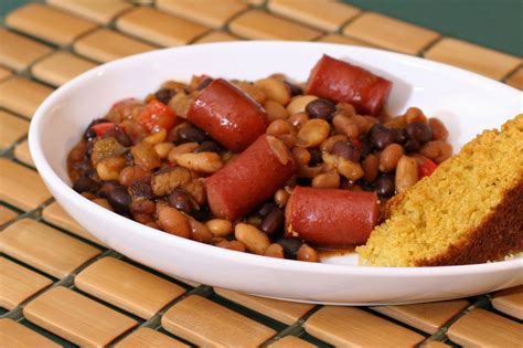 In a large bowl, combine all ingredients except the cheese; Crock Pot Beans and Hot Dogs Recipe