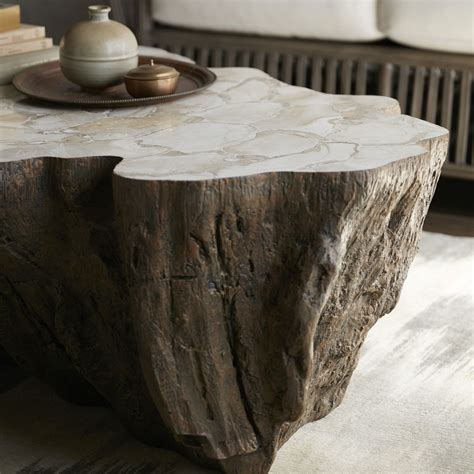 Trunk shaped clam shell lava coffee table stonecast top with inlaid fossilized clam shell on stonecast base made to resemble tree trunk each piece varies due to natural elements for indoor use only. PALECEK CHLOE FOSSILIZED CLAM LAVA COFFEE TABLE Inlaid ...