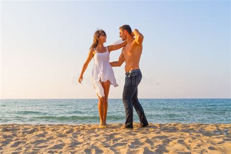 Oung Couple Teasing One Another At The Beach Stock Image Image Of