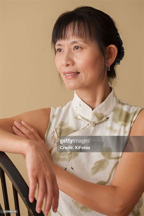 Mature Chinese Woman In Traditional Dress Qipao High Res Stock Photo