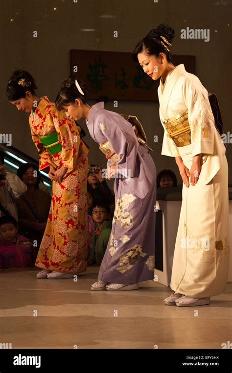 Japanese Women Bowing at Kimono Show at Nishijin Textiles Stock Photo