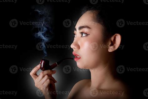 Woman Smoking A Pipe Tobacco On Black Background Stock Photo At Vecteezy