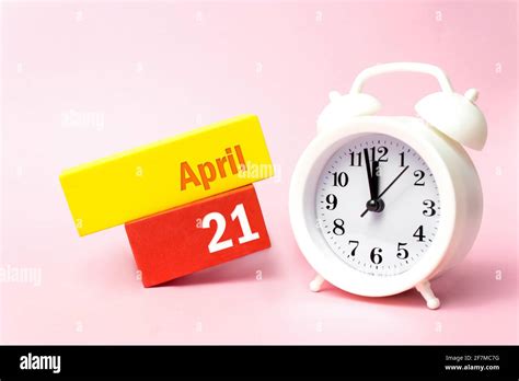 April 21st Day 21 Of Month Calendar Date White Alarm Clock On
