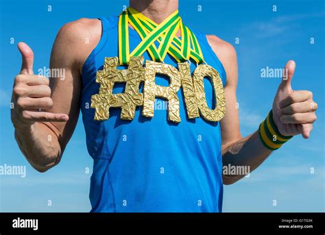 hashtag rio gold medal athlete celebrating with shaka hand signs in blue shirt outdoors close up