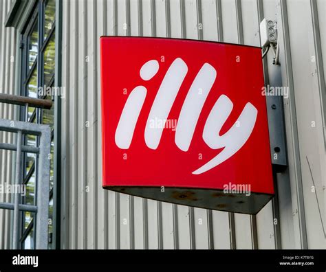 Illy Logo Is Mounted To A Wall Above The Entrance To One Of Their
