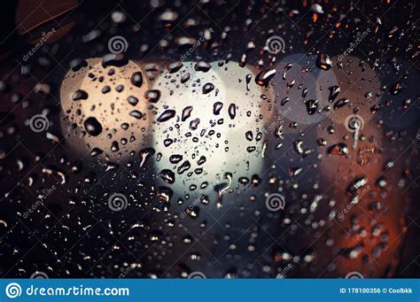 Blurred Drop Of Rain On Transparent Glass Window Surface Against