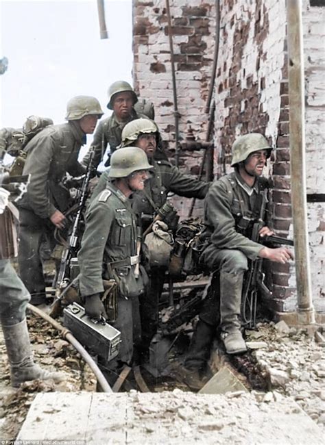 Visibly Battle Tested German Soldiers Peer Around The Corner Of A
