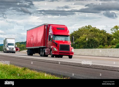 Horizontal Shot Of A Red Semi Tractor Trailer Truck Traveling The