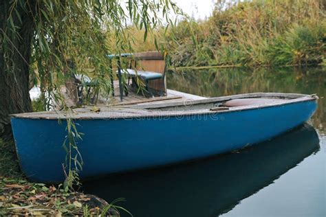 Light Blue Wooden Boat On Lake Near Pier Stock Image Image Of Light