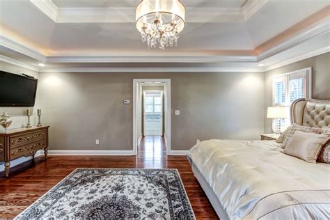 Tray ceilings add architectural interest to a room by creating depth and making the ceiling seem higher and the room seem larger. Master suite bedroom featuring a double tray hipped ...