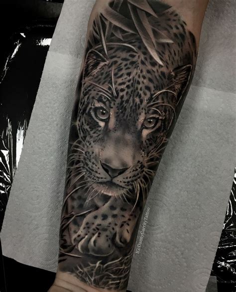 A Mans Arm With A Black And Grey Tattoo Of A Leopard On It