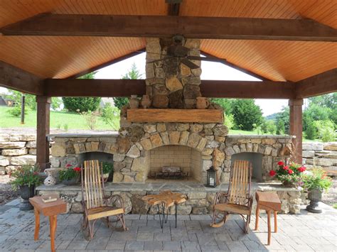 Natural Stone Fireplace With Wood Storage And Brick Paver Patio
