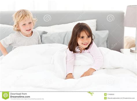 Happy Brother And Sister Playing In A Bed Stock Image