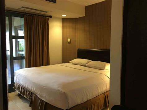 Guests enjoy the comfy beds. Room & Suites - Deluxe Suites Jakarta Hotel - Grand Tropic ...