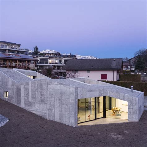 This Robust Concrete House In Savièse Steps Down The Side Of A Hill And