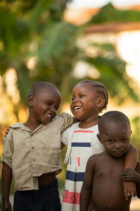 Happy African Children Embracing On Street · Free Stock Photo