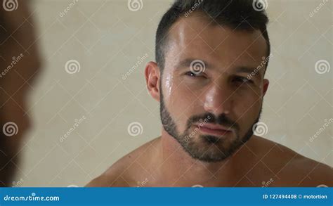 handsome man admiring himself after shaving caring of his beard morning ritual stock footage