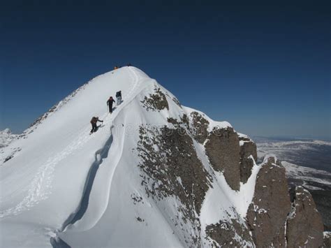 People Hiking Through Snow To The Mountain Peak Stock Image Image Of