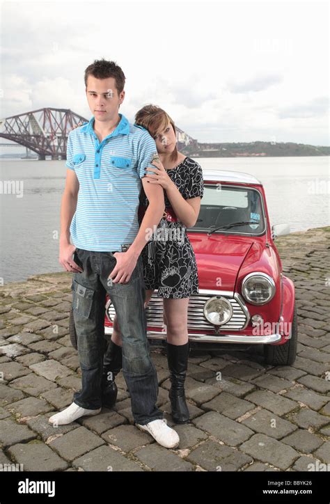 Young Boy And Girl Models Pictured With A Red Mini Cooper On A Pier