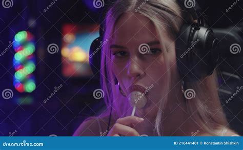 Blonde Gamer Girl Streamer Playing With A Lollipop In Her Mouth While Looking In The Camera