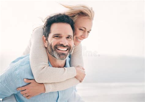 theres never a dull moment with her a mature couple spending a day at the beach stock image